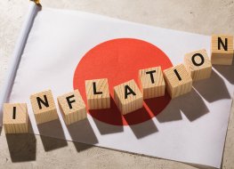 Japanese flag and wooden cubes with text, concept on the theme of inflation in Japan