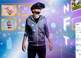 Image of standing man with a virtual reality camera on his eyes and with NFT written vertically 