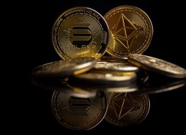 Solana coin with an Ethereum coin behind it that is slightly blurred against a black background