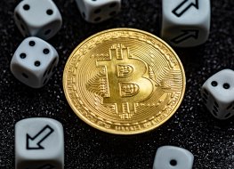 Bitcoin (BTC) coin and dice, including those showing arrows pointing to different directions.