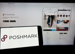 Phone screen with Poshmark (POSH) logo.