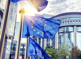 EU flags waving outside the European Parliament