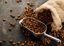 Coffee beans falling out of bag with scoop