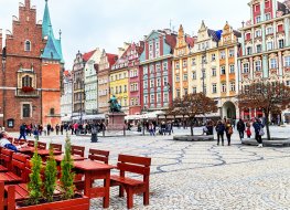 People walking, resting on the famous, old market square in Wroclaw, Poland