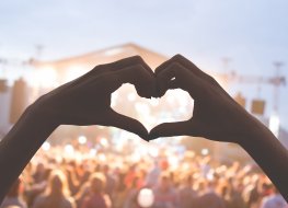 Handmade heart symbol at a music festival 
