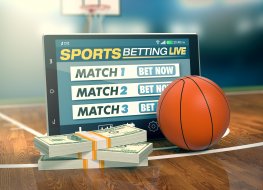 App for sport bets, stacks of banknotes and a basketball 