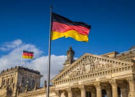 German flags waving in the wind in the famous Reichstag building, the seat of the German Parliament (Deutscher Bundestag)