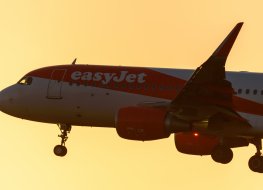 easyJet plane flying against sun
