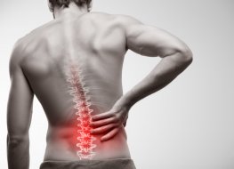 Man holding lower back in pain