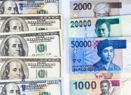 Close up view of US Dollar and Indonesia Rupiah indicating strong currency exchange rate