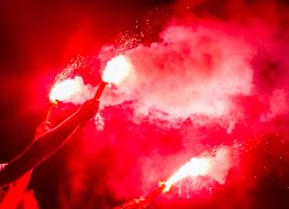 Football fans burning flares during a match 