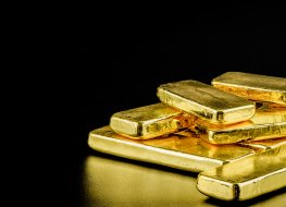 Gold bars scattered on a black background 