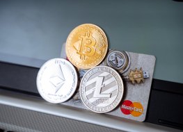 Cryptocurrency coins on a MasterCard credit card.