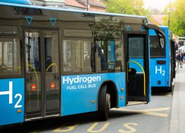 A hydrogen bus pulling up to pick up passengers