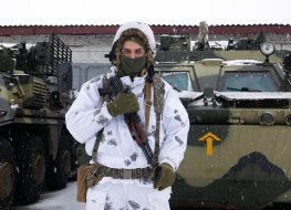 A Russian soldier in front of a tank