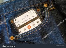 Smartphone in front jeans pocket showing Shein app 