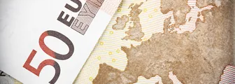 Two €50 banknotes on a map of Europe