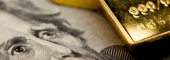 Close-up of a $20 banknote and gold bullion