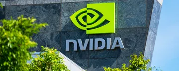 Nvidia logo and sign on headquarters. Blurred foreground with green trees - Santa Clara, California, USA - 2020