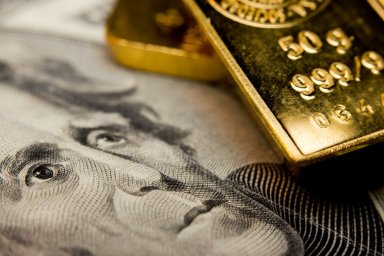 Close-up of a $20 banknote and gold bullion