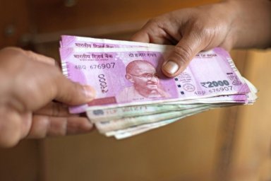 Small stack of Indian rupee notes changing hands