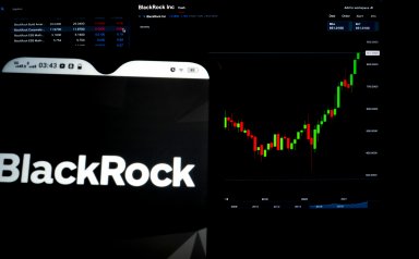 BlackRock Inc. logo displayed on a smartphone with the stock chart of BlackRock Inc. in the background.