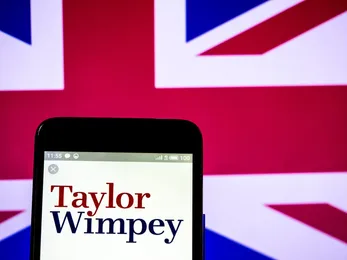 Smartphone displaying the Taylor Wimpey logo against a Union Jack background, representing the British housebuilding company.