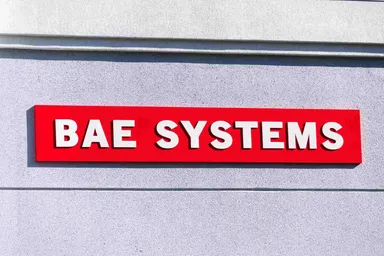 BAE Systems logo mounted on the exterior of a company building, representing the global aerospace, defence, and security technology company.