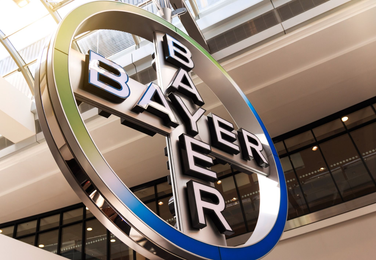 Large Bayer logo sign displayed inside a modern corporate building