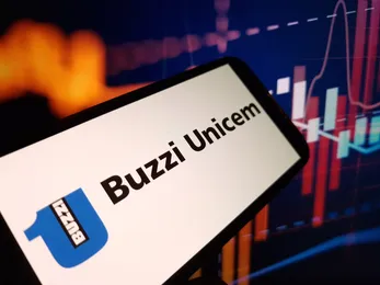 Buzzi Unicem logo on a mobile device with financial charts, representing the cement and construction materials company in the stock market context
