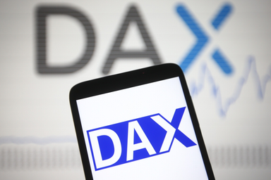 Smartphone displaying the DAX logo on screen with a blurred background showing the DAX name