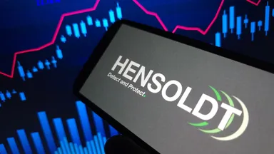 Hensoldt logo displayed on a smartphone screen with financial charts in the background