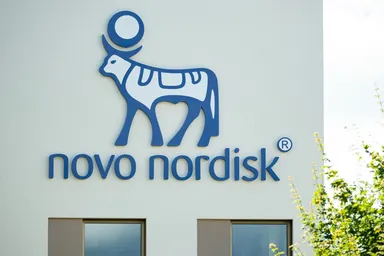 Novo Nordisk logo displayed on the exterior wall of a modern building