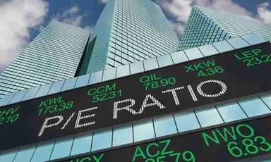 Electronic stock market ticker displaying financial quotes in front of modern skyscrapers, representing global financial markets, trading activity, and investment performance. 