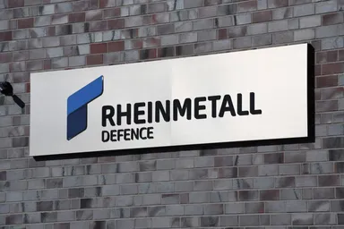Rheinmetall Defence logo on a sign mounted on a brick wall
