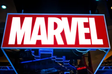Illuminated Marvel logo on a red background.