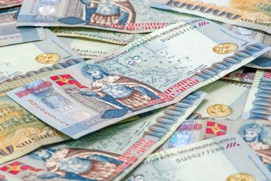 Close-up of Armenian Dram in AMD 100,000 banknotes. Business and finance concept. Macro composition with selective focus and blurred background