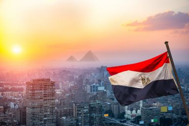 View of evening Cairo from above and egyptian flag