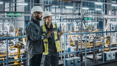 Engineers working in an industrial manufacturing facility.