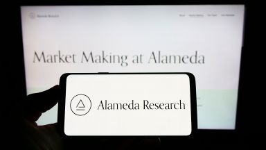 Alameda Research logo on smartphone and computer screen 