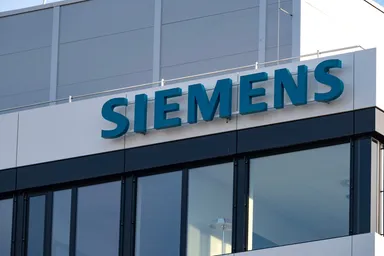Siemens logo on the exterior of a modern office building with glass windows
