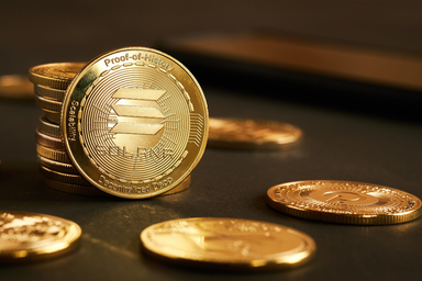 Close-up of Solana cryptocurrency coins on a dark surface.