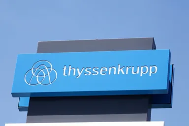 Thyssenkrupp logo on a blue sign against a clear sky