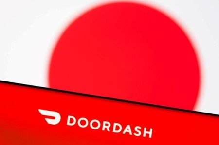 Doordash logo is seen on a smartphone in front of displayed Japan flag in this illustration picture taken June 9, 2021.