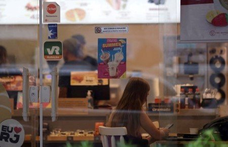 Stickers of meal vouchers companies are pictured on the entrance door of a coffee shop, in Rio de Janeiro, Brazil March 28, 2023. 