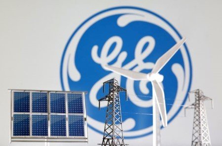 Miniatures of windmill, solar panel and electric pole are seen in front of General Electric logo in this illustration taken January 17, 2023. 