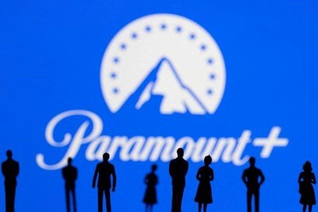 Toy figures of people are seen in front of the displayed Paramount + logo, in this illustration taken January 20, 2022.