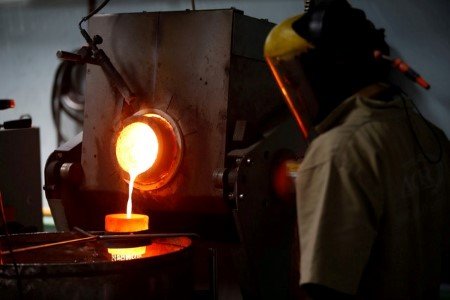 A file photo shows an employee pouring liquid gold into a mould for the production of an ingot during the refining process at AGR (African Gold Refinery) in Entebbe, Uganda, October 4, 2018. 