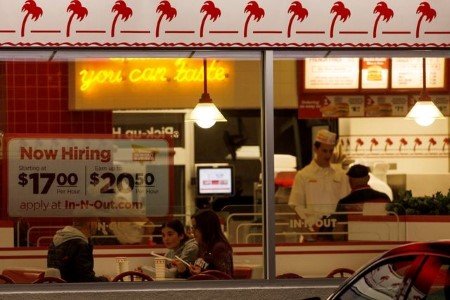 A file photo shows a "Now hiring" sign on the window of an IN-N-OUT fast food restaurant in Encinitas, California, U.S., May 9, 2022. A file photo shows a "Now hiring" sign on the window of an IN-N-OUT fast food restaurant in Encinitas, California, U.S., May 9, 2022.