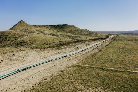 A file photo of an extension of Denbury Inc's Greencore carbon pipeline is ready to be lowered into its trench, in Montana, U.S., 2021. 